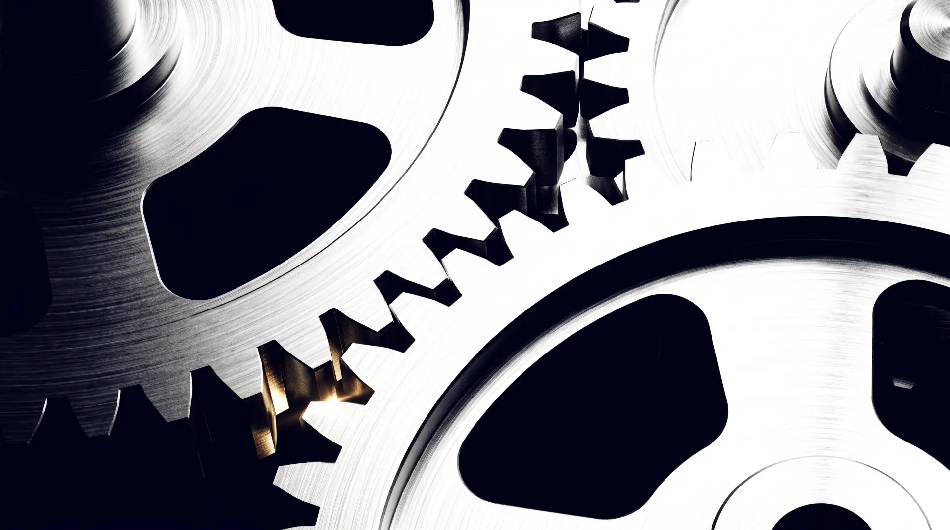 Interlocking steel gears with one gold-lit tooth